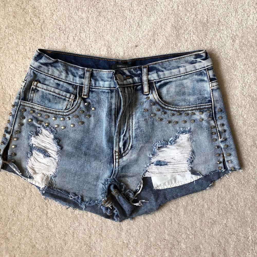 Ripped and studded mid rise jean shorts